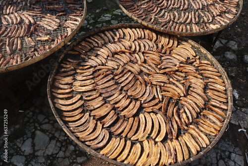 Bananas are being dried in the sun to make banana cakes in plastic