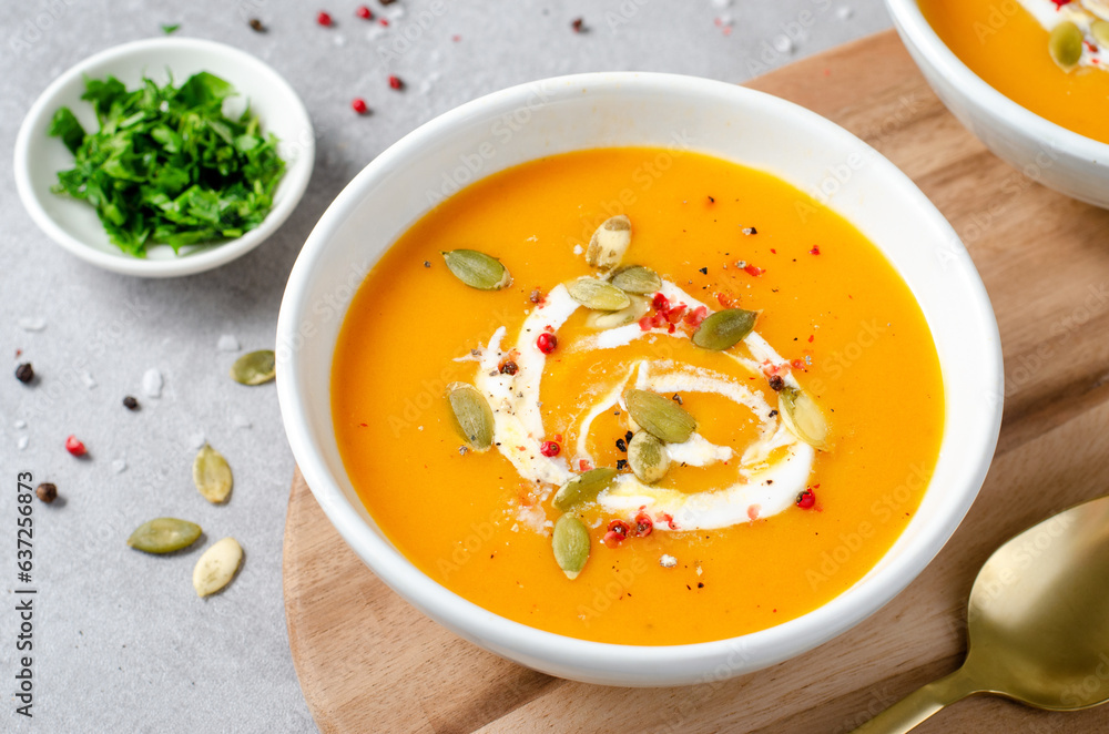 Pumpkin Soup, Tasty Homemade Pumpkin, Sweet Potato, Carrot Soup in a Bowl on Bright Background