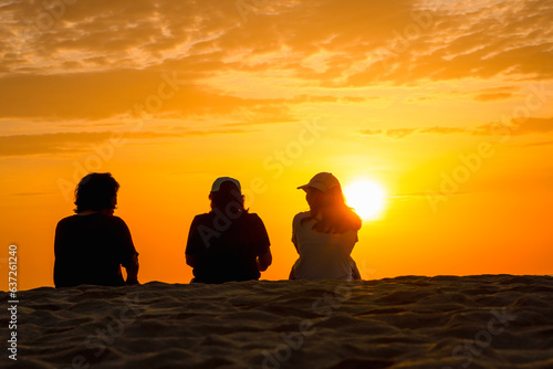 Sunrise at My Khe beach, Danang, Vietnam. Vietnamese and tourists exercise along Da Nang beach at sunrise. silhouette many people walking seaside, relaxing, jogging on beach