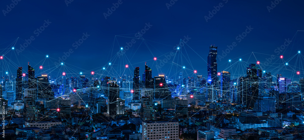 Modern city with wireless network connection and city scape concept.Wireless network and Connection technology concept with city background at night.

