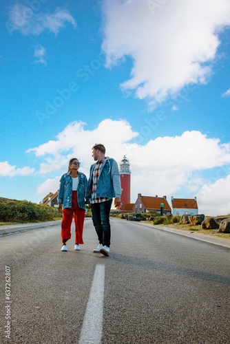 a couple visit the lighthouse of the Dutch Island Texel  men  and woman on vacation Texel