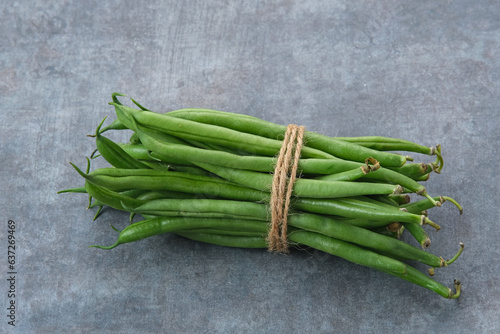 Buncis or Fresh raw string bean, legumes contain protein on dark background

