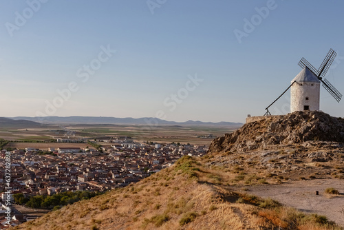 Mills in the town of Consuegra. Landscape of several white windmills and brown windmills on the hill. ancient architecture. Farm houses.