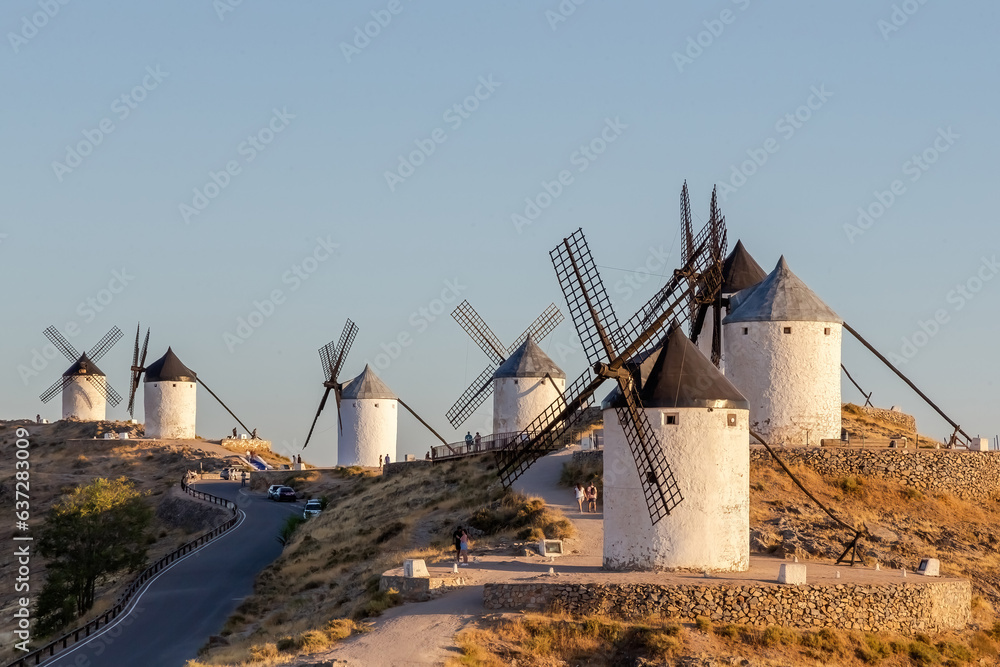 Mills in the town of Consuegra. Landscape of several white windmills and brown windmills on the hill. ancient architecture. Farm houses. Mills in the town of Consuegra. Landscape of several white windmills and brown windmills on the hill. ancient architecture. Farm houses.