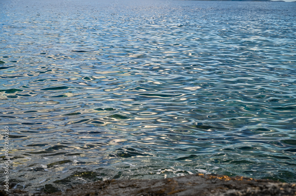 Water surface. Aerial drone view of sea waves. Sun reflection on water surface. 