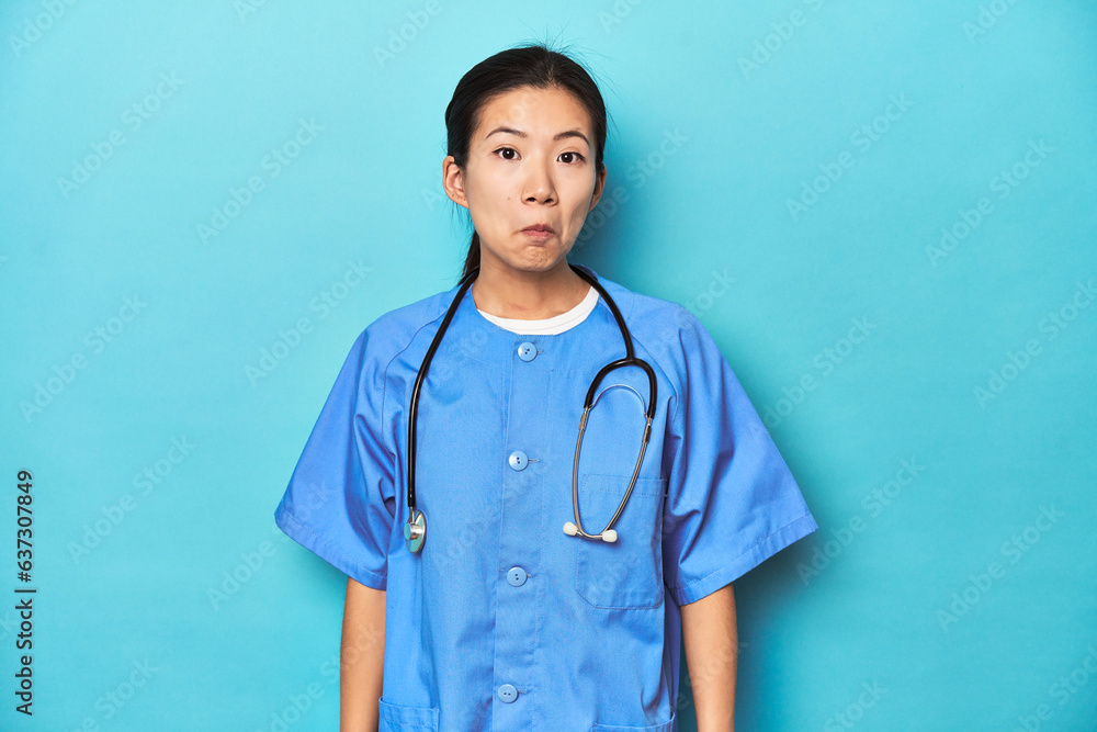 Asian nurse with stethoscope, medical studio shot, shrugs shoulders and open eyes confused. Asian nurse with stethoscope, medical studio shot, shrugs shoulders and open eyes confused.