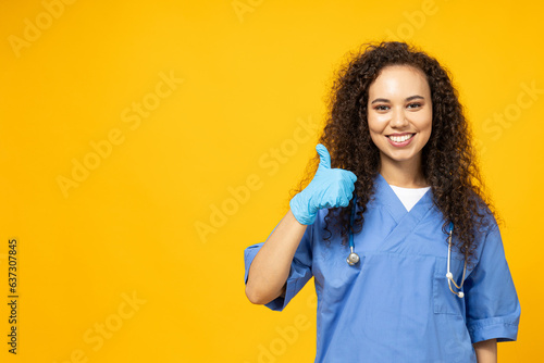 An attractive young girl in a blue nurse's uniform on a yellow background