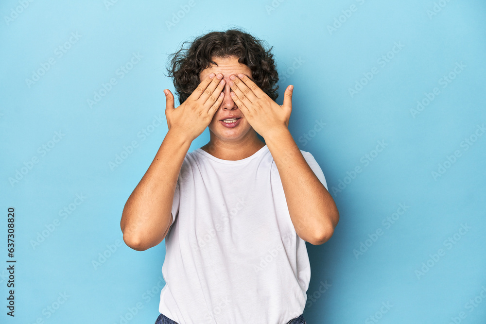 Young Caucasian woman with short hair afraid covering eyes with hands. Young Caucasian woman with short hair afraid covering eyes with hands.