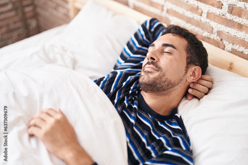 Young hispanic man lying on bed sleeping at bedroom Young hispanic man lying on bed sleeping at bedroom