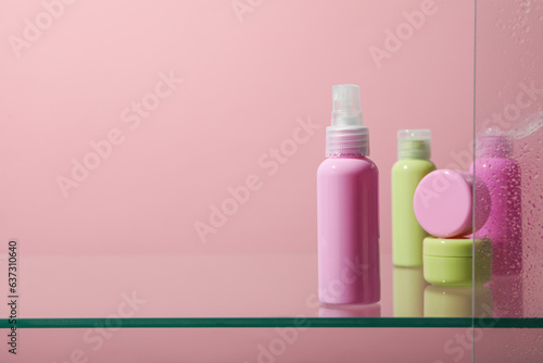 A shelf in the bathroom with care products.