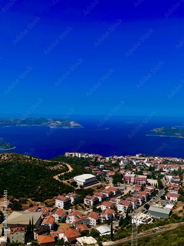 Unrealistically beautiful view of a small town and a clear blue sea.