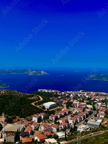 Unrealistically beautiful view of a small town and a clear blue sea.