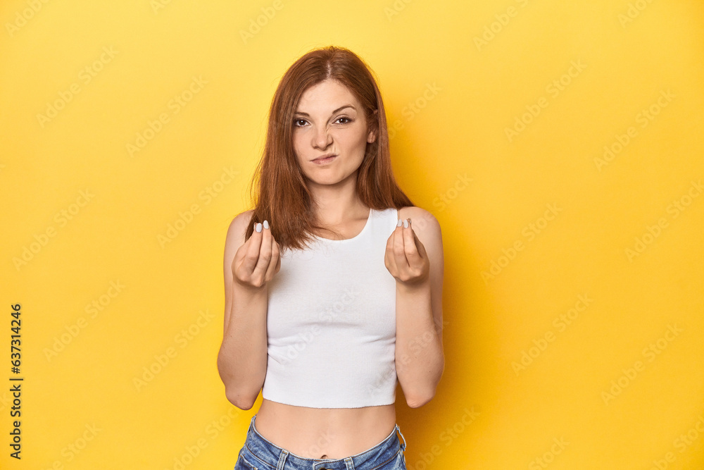 Redhead in white tank top, relaxed studio pose showing that she has no money. Redhead in white tank top, relaxed studio pose showing that she has no money.