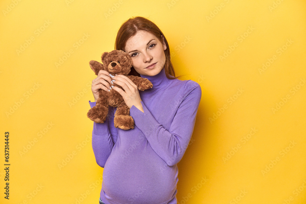 Pregnant redhead with teddy bear, awaiting baby's arrival. Pregnant redhead with teddy bear, awaiting baby's arrival.