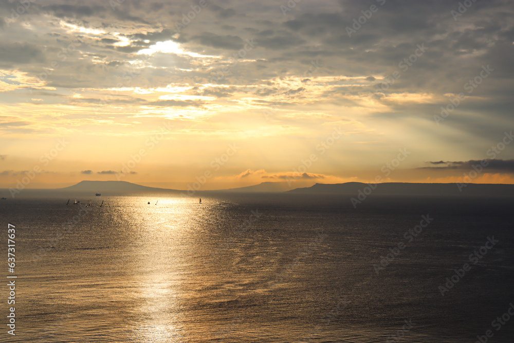 Fototapeta premium Beautiful evening sky. Sunset in the city by the sea.