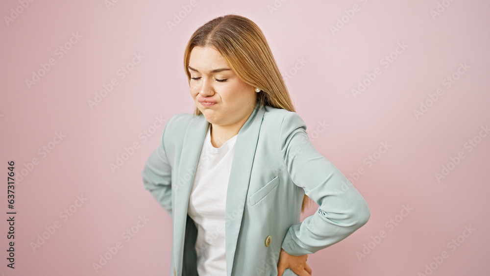 Young blonde woman business worker suffering for backache over isolated pink background