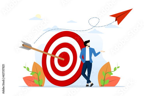 concept of business goal, aim or target, intent and resolution to achieve success, aspiration and motivation to achieve goal, confident businessman standing with arrow on target at archery target.