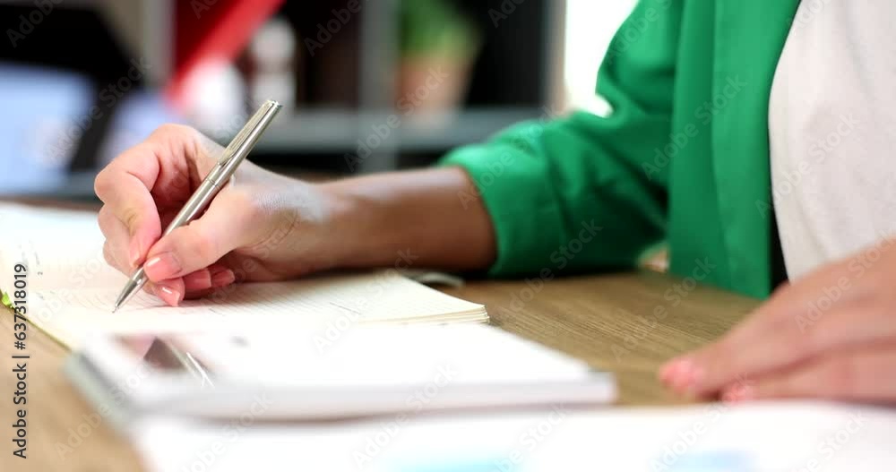 Female hands using calculator, calculating finances at workplace. Female hands and paper document economist or financier writes report