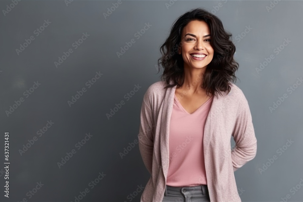 Medium shot portrait of an Indian woman in her 40s in a minimalist background Medium shot portrait of an Indian woman in her 40s in a minimalist background