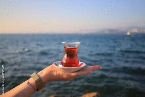 Photography Turkish tea on the hand of a girl