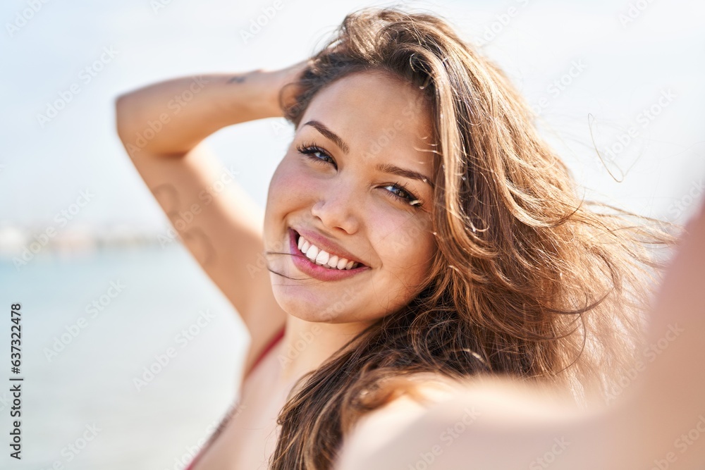 Young beautiful hispanic woman tourist smiling confident make selfie by camera at beach Young beautiful hispanic woman tourist smiling confident make selfie by camera at beach