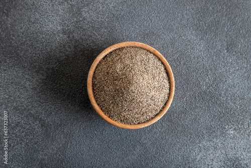 Powder black pepper on black background,top view
