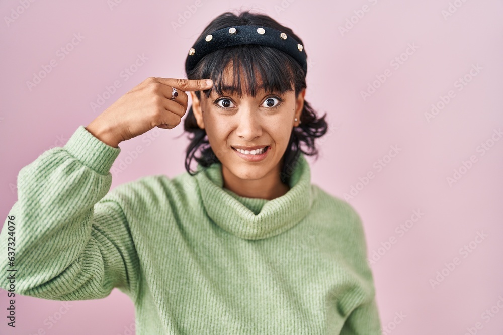 Young beautiful woman standing over pink background pointing unhappy to pimple on forehead, ugly infection of blackhead. acne and skin problem Young beautiful woman standing over pink background pointing unhappy to pimple on forehead, ugly infection of blackhead. acne and skin problem