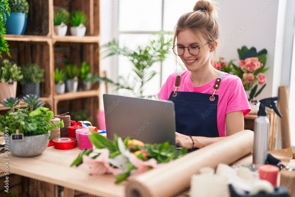 Young blonde woman florist smiling confident using laptop at flower shop Young blonde woman florist smiling confident using laptop at flower shop