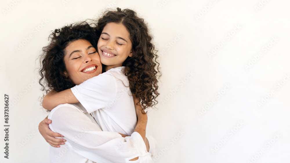 Mother daughter love. Happy latin mom hugging with her child girl, loving family bonding and enjoying spending time with each other, panorama, copy space Mother daughter love. Happy latin mom hugging with her child girl, loving family bonding and enjoying spending time with each other, panorama, copy space