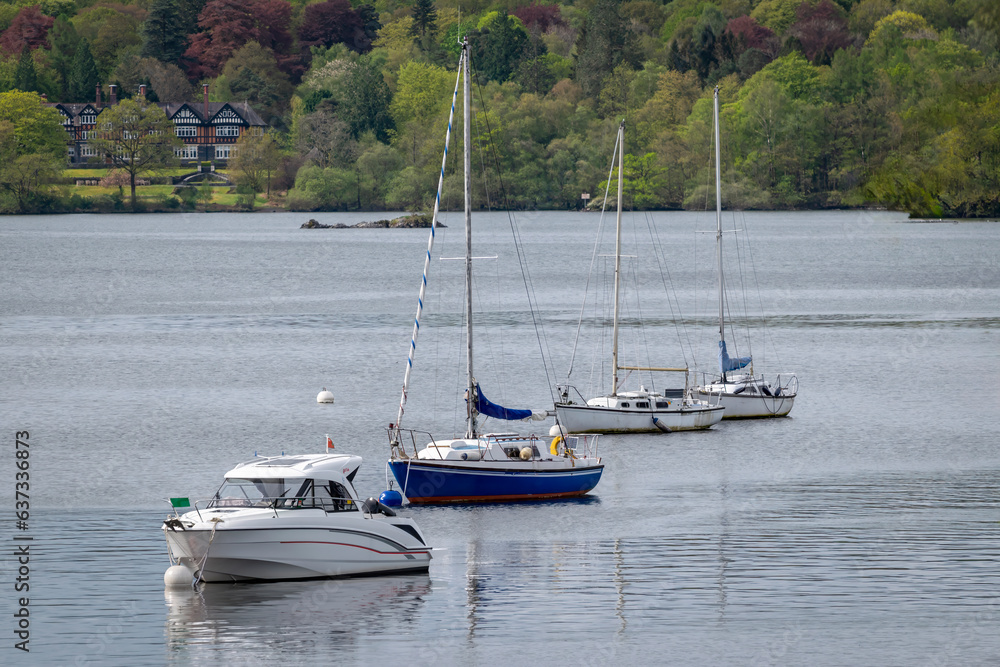 Four boats in a line on Ambleside Lake in the Lake District Cumbria
