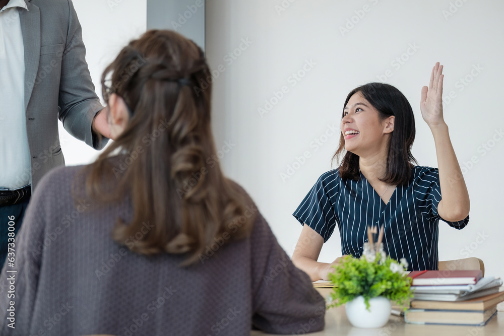 Fototapeta premium Positive friendly African American English tutor giving language courses to group of interested adults of different ages and nationalities sitting around table in classroom, Education concept