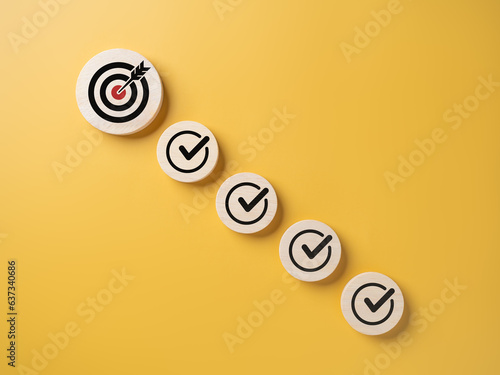 Checklist, Task list, Survey and assessment, Quality Control, Goals achievement, and business success. To do lists for achieving the target. Check mark and target goals dartboard on wooden circles.