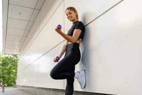 pretty young smiling woman doing sports in the morning in stylish black sport outfit sportswear, skinny strong body, healthy fit lifestyle