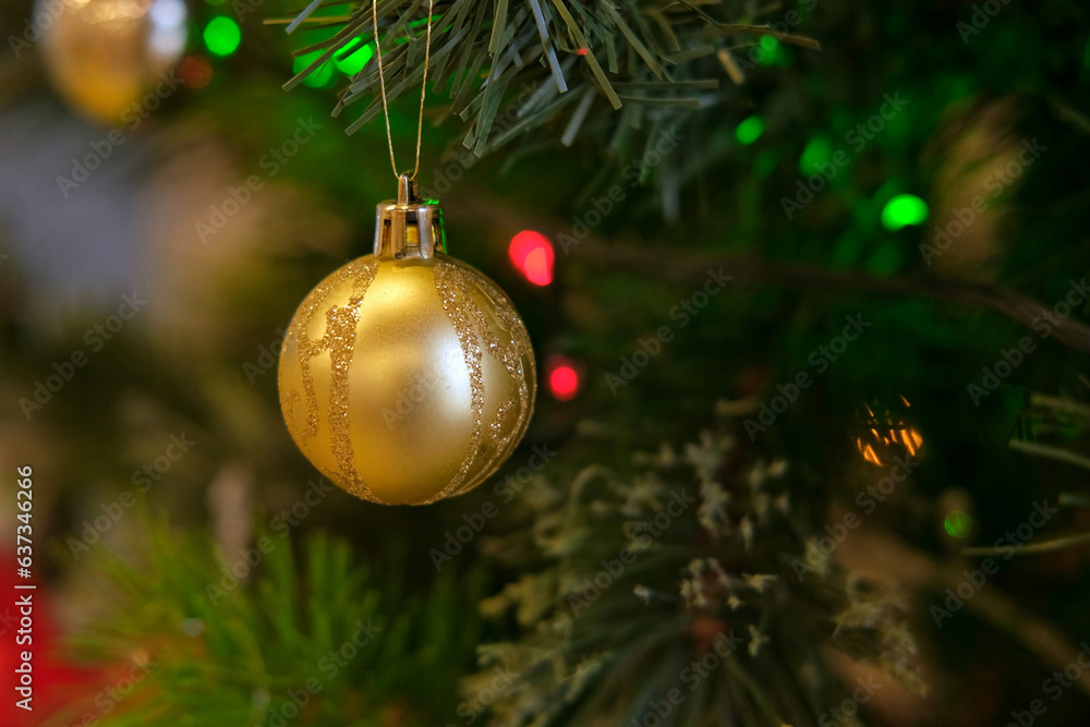 Christmas decoration on fir branches. Toy for Christmastree. Golden
