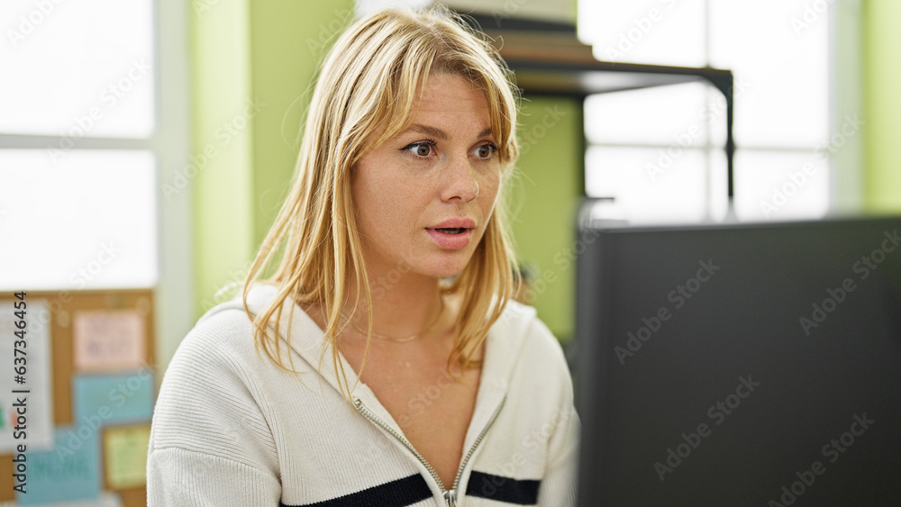 Young blonde woman business worker using computer working at office Young blonde woman business worker using computer working at office