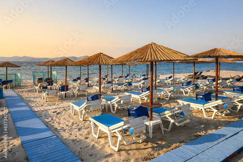 Fototapeta Naklejka Na Ścianę i Meble -  Sun loungers on sandy beach of Marmari. The Greek island of Kos