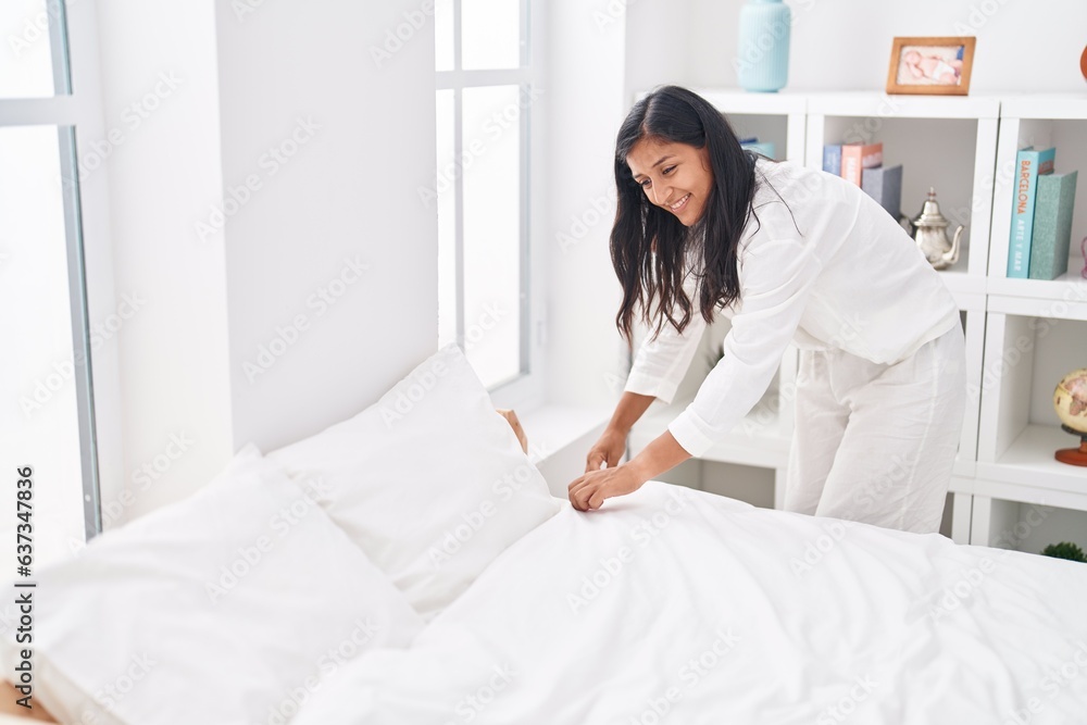 Young beautiful hispanic woman smiling confident make bed at bedroom Young beautiful hispanic woman smiling confident make bed at bedroom