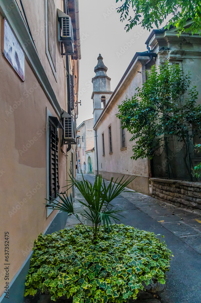 Fototapeta premium A view down a street towards the church in the town of Izola, Slovenia in summertime