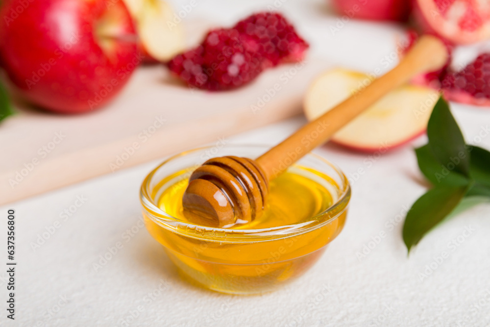 Rosh hashanah, jewish holiday, concept: honey, apple and pomegranate with cutting board, close up Rosh hashanah, jewish holiday, concept: honey, apple and pomegranate with cutting board, close up