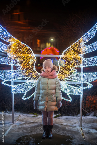 girl on the background of luminous wings evening time