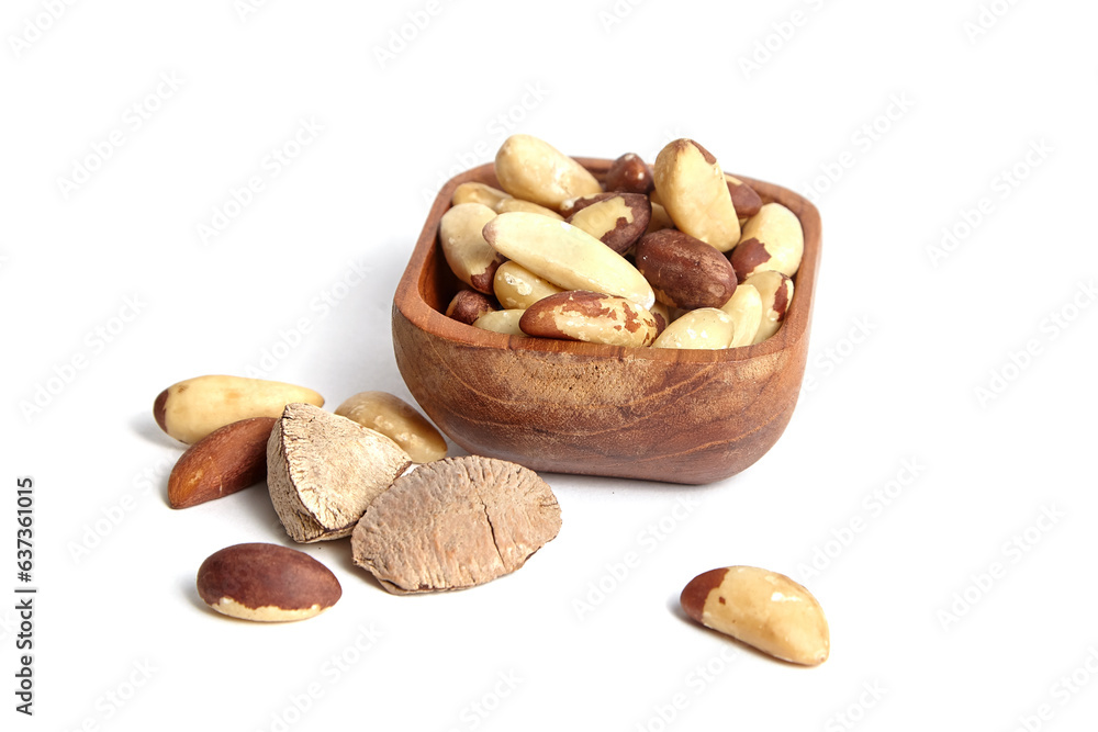 Brazil nuts in wooden bowl isolated on white background. Shelled Brazil nuts, a natural source of protein Brazil nuts in wooden bowl isolated on white background. Shelled Brazil nuts, a natural source of protein