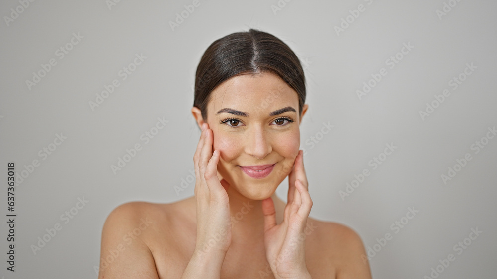 Young beautiful hispanic woman smiling confident massaging face over isolated white background Young beautiful hispanic woman smiling confident massaging face over isolated white background