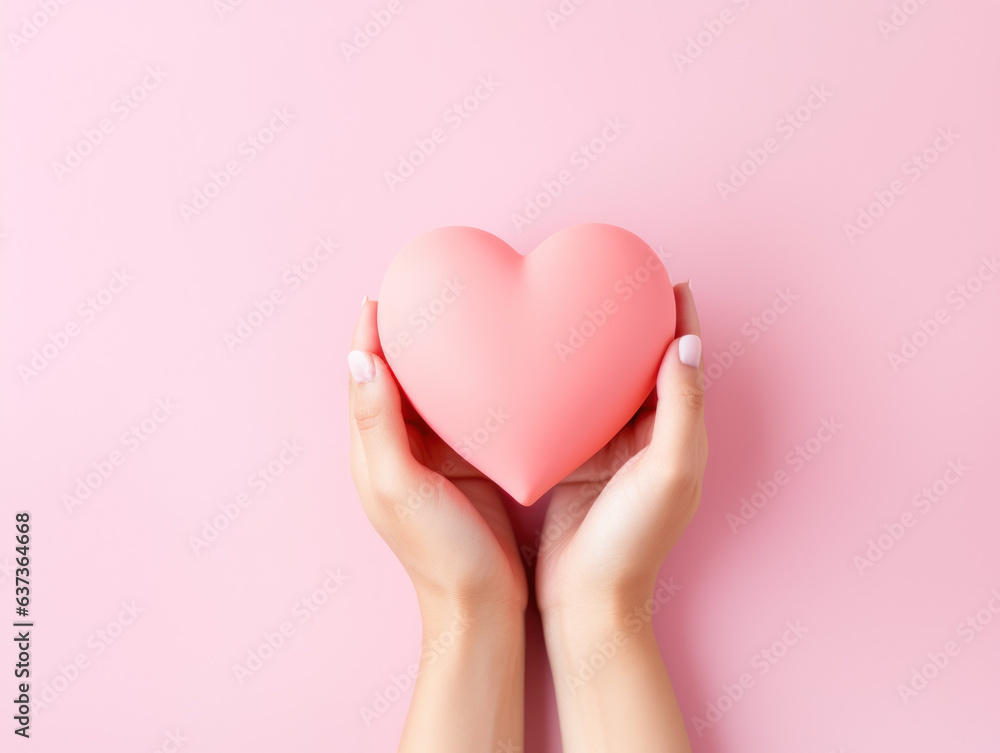 Valentine's Day, pink heart made of paper are held in the hand in love. Top view. Copy space. Valentine's Day, pink heart made of paper are held in the hand in love. Top view. Copy space.