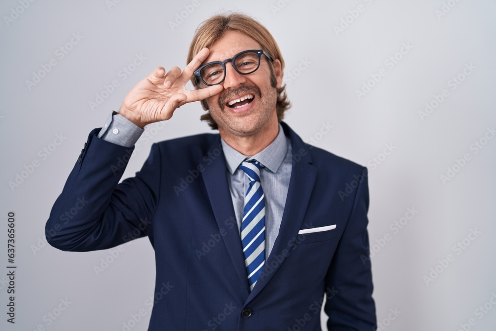 Caucasian man with mustache wearing business clothes doing peace symbol with fingers over face, smiling cheerful showing victory Caucasian man with mustache wearing business clothes doing peace symbol with fingers over face, smiling cheerful showing victory