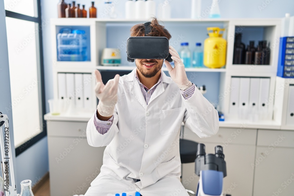 Young arab man scientist using virtual reality glasses working at laboratory Young arab man scientist using virtual reality glasses working at laboratory