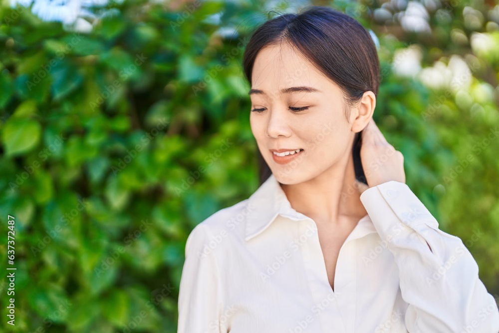 Young chinese woman smiling confident looking to the side at park Young chinese woman smiling confident looking to the side at park