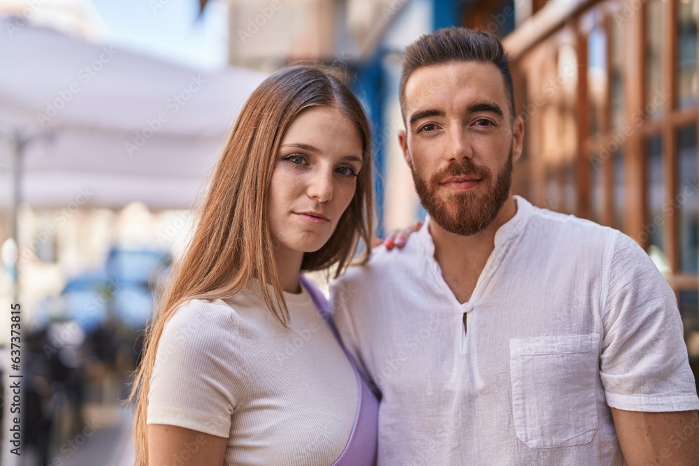 Man and woman couple hugging each other with relaxed expression at street Man and woman couple hugging each other with relaxed expression at street