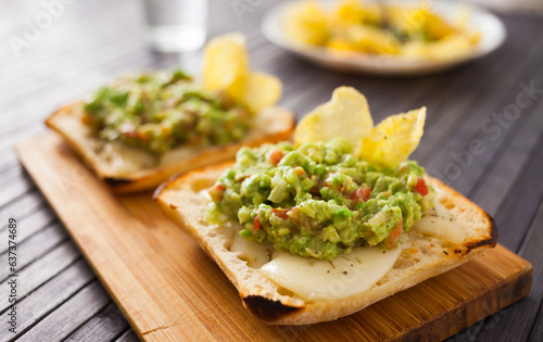 healthy breakfast. toasted italian ciabatta bread with melted cheese and avocado puree