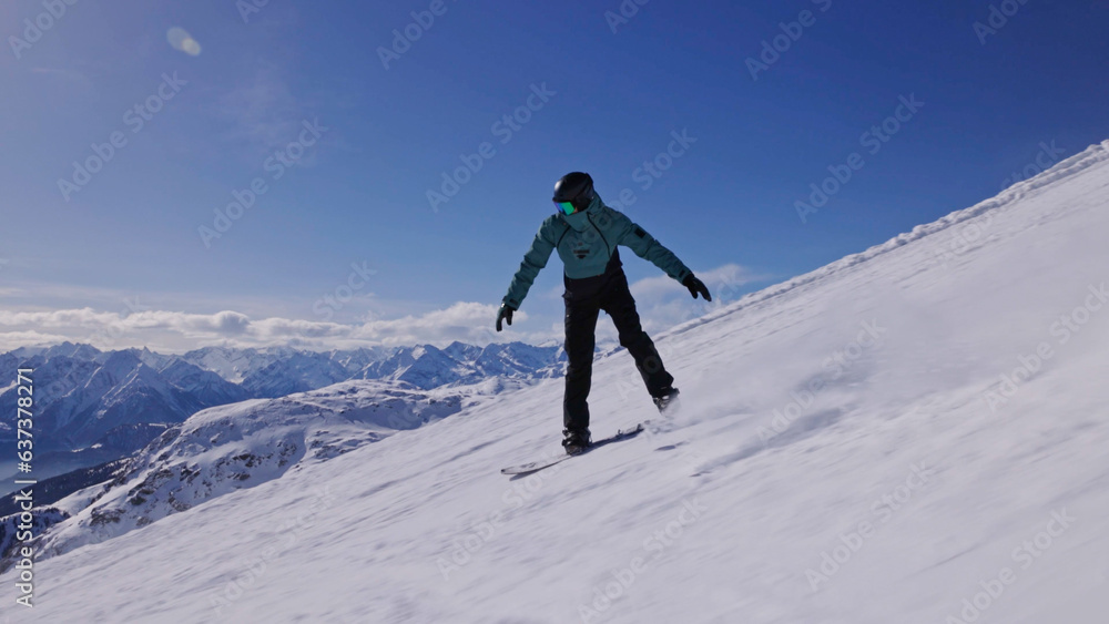 Snowboarder on piste in high mountains, freeze motion