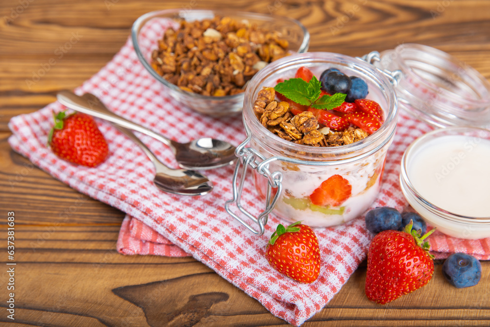 Bowl of granola with yogurt and fresh berries on a texture table. Yogurt berries, acai bowl, spirulina bowl. Healthy food, balanced breakfast. Strawberries, blueberries, kiwi, peach, almonds and chia. Bowl of granola with yogurt and fresh berries on a texture table. Yogurt berries, acai bowl, spirulina bowl. Healthy food, balanced breakfast. Strawberries, blueberries, kiwi, peach, almonds and chia.